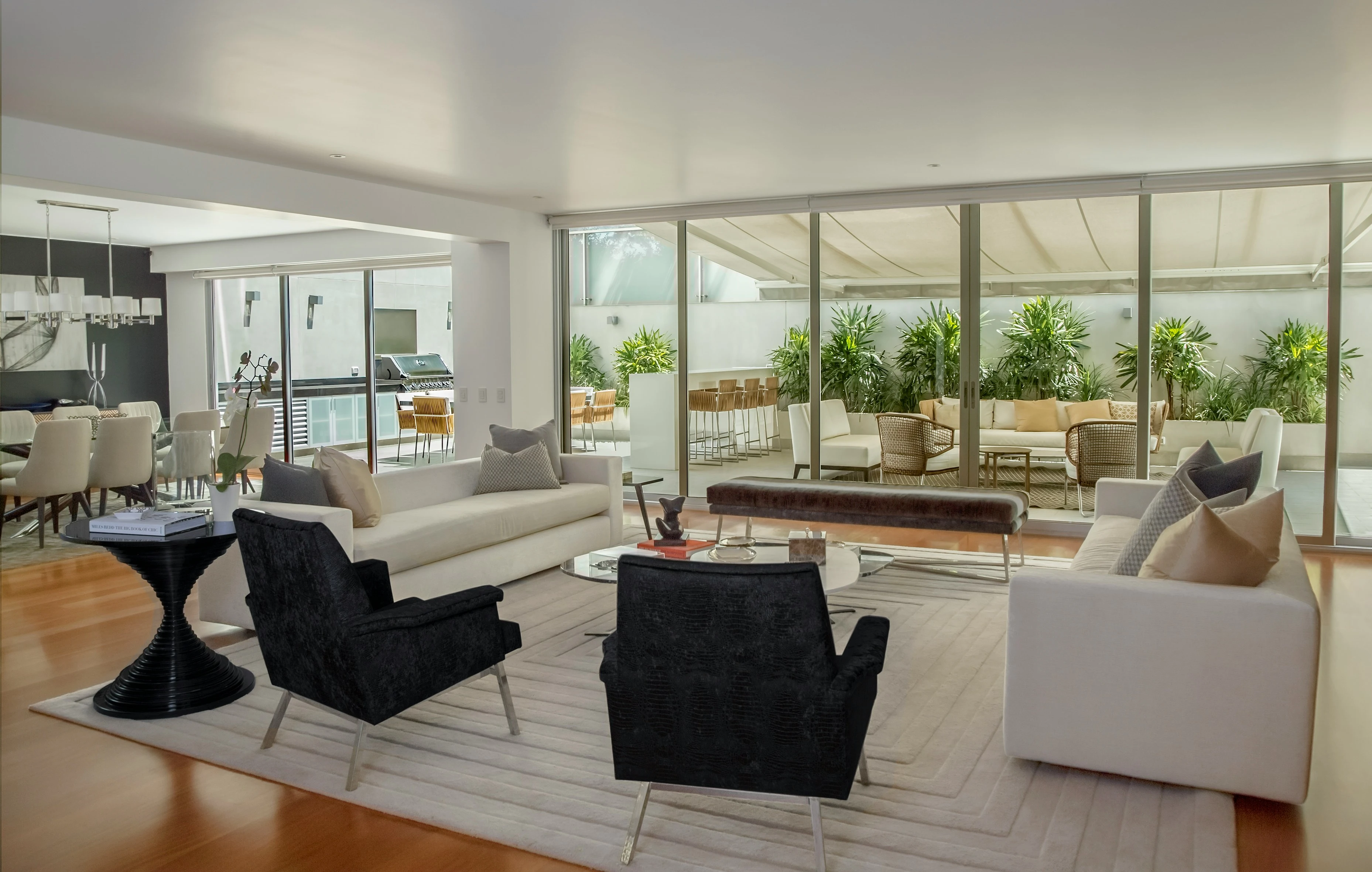 Living room opening onto a terrace through full height sliding glass